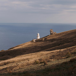 lighthouse hill sea ocean landscape wallpaper unsplash freetoedit